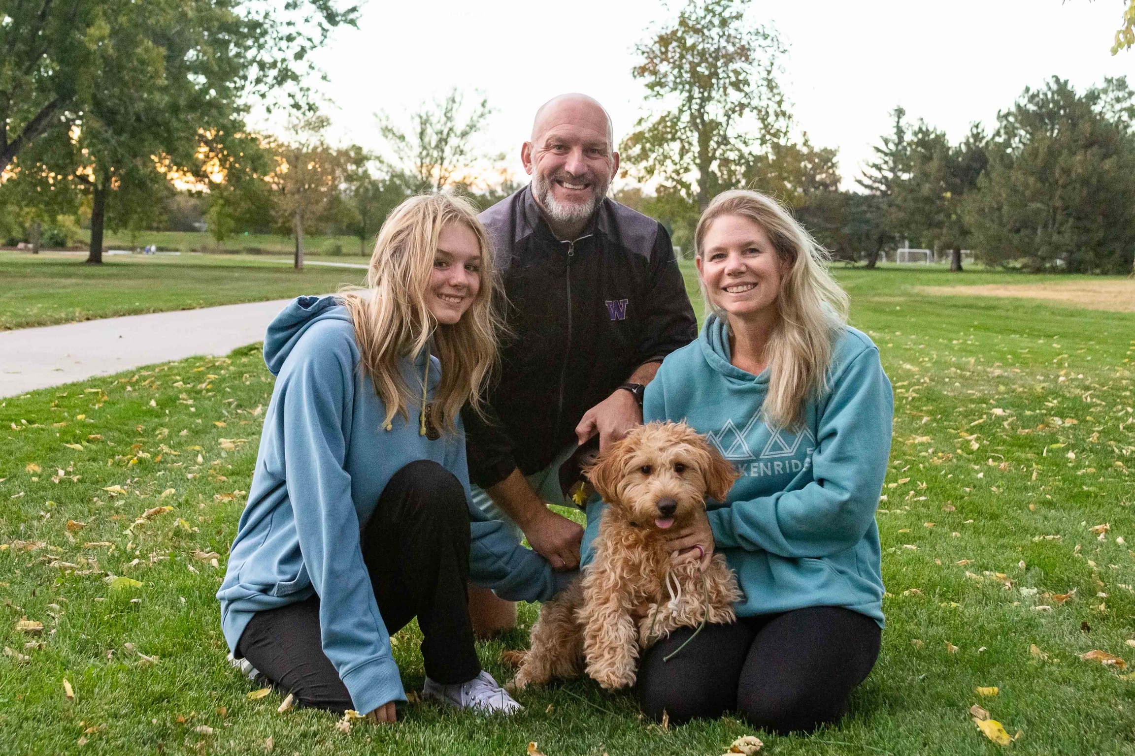 A happy family with their well-trained dog in Loveland, Colorado